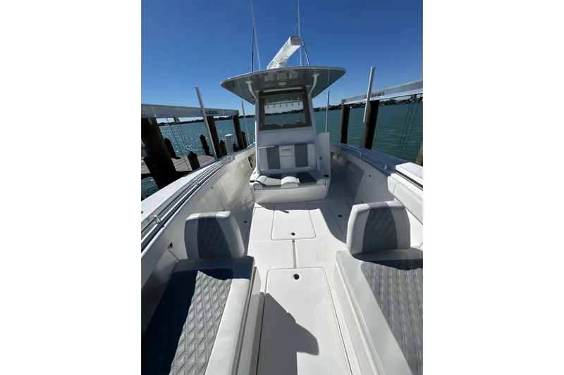 Reel Advice Yacht Photos Pics 2019 Invincible 39 Open Fisherman boat docked, showcasing spacious seating and sleek design.