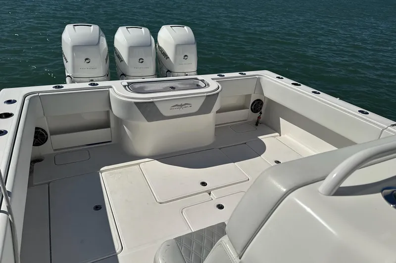 Reel Advice Yacht Photos Pics 2019 Invincible 39 Open Fisherman boat with triple engines on calm water.