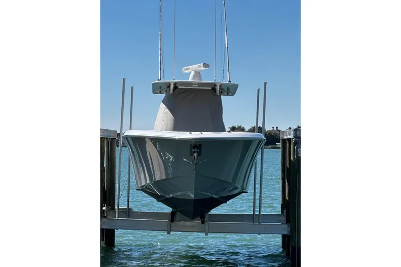 Reel Advice Yacht Photos Pics 2019 Invincible 39 Open Fisherman boat docked on a lift, clear blue sky.