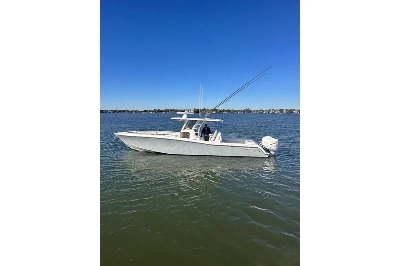 Reel Advice Yacht Photos Pics 2019 Invincible 39 Open Fisherman boat on calm water under clear blue sky.