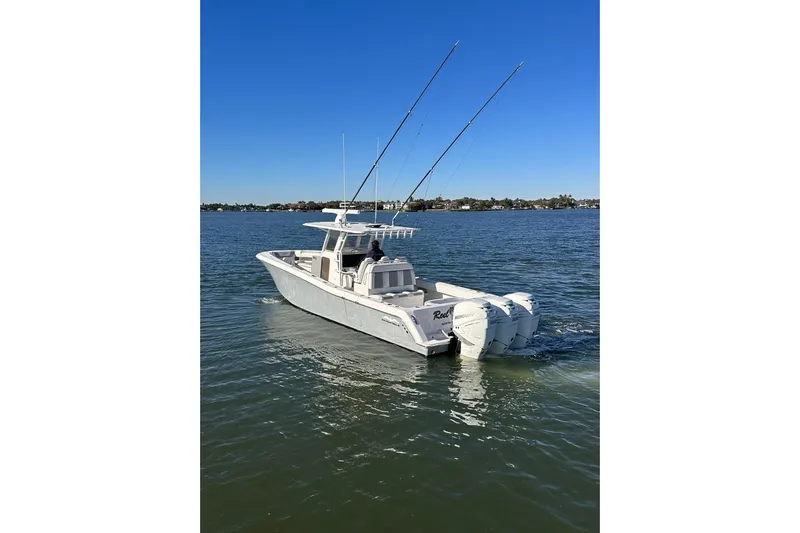 Reel Advice Yacht Photos Pics 2019 Invincible 39 Open Fisherman boat on calm water, clear blue sky.