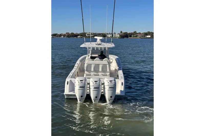 Reel Advice Yacht Photos Pics 2019 Invincible 39 Open Fisherman boat with triple engines on calm water.