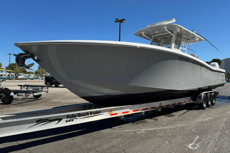 Reel Advice Yacht Photos Pics 2019 Invincible 39 Open Fisherman boat on trailer, parked outdoors under clear blue sky.