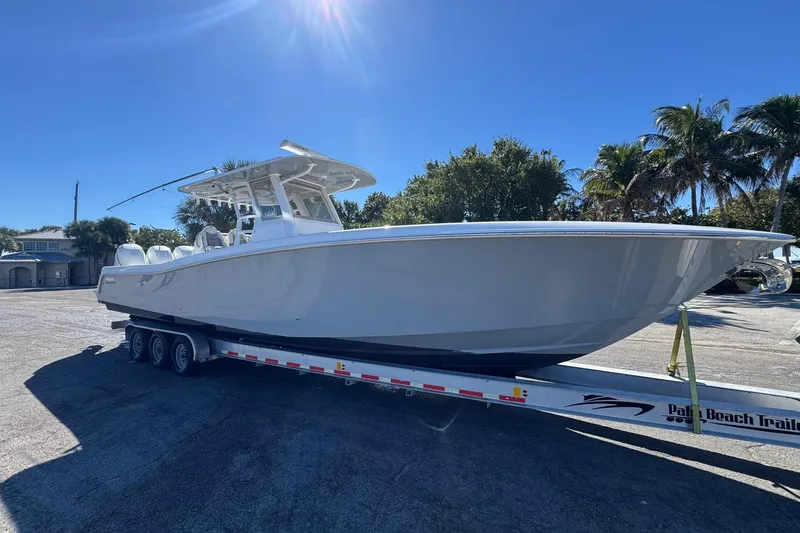 Reel Advice Yacht Photos Pics 2019 Invincible 39 Open Fisherman boat on trailer under clear blue sky.
