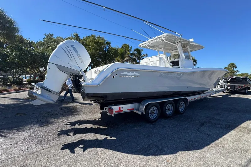 Reel Advice Yacht Photos Pics 2019 Invincible 39 Open Fisherman boat on trailer, parked outdoors under clear blue sky.