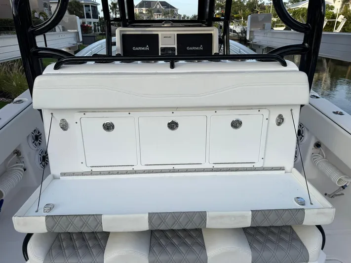  Yacht Photos Pics 2023 Invincible 33 Catamaran interior with white seating and storage compartments.