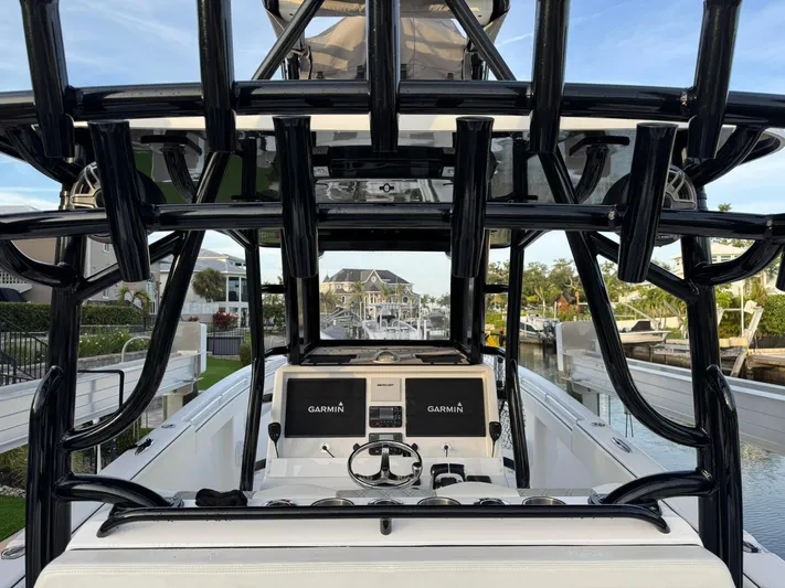  Yacht Photos Pics 2023 Invincible 33 Catamaran with Garmin displays, docked in a scenic marina.