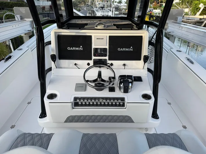  Yacht Photos Pics 2023 Invincible 33 Catamaran helm with dual Garmin displays and modern controls.
