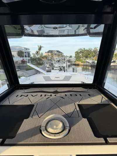  Yacht Photos Pics 2023 Invincible 33 Catamaran interior view with waterfront background.