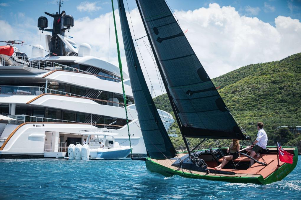 Saffier 24 Lite sailboat cruising near a luxury yacht, 2026 model, in scenic waters.