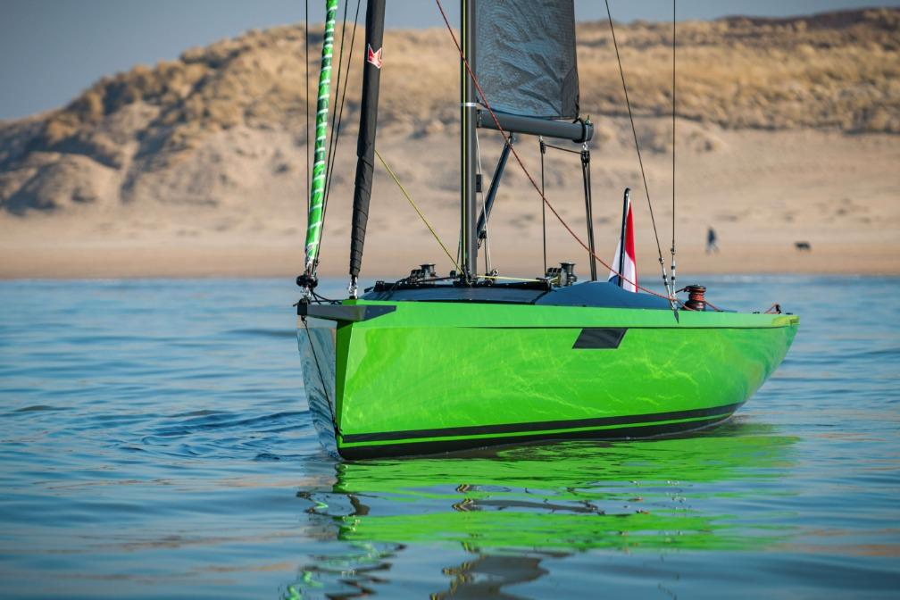 2026 Saffier 24 Lite sailboat with vibrant green hull on calm water.