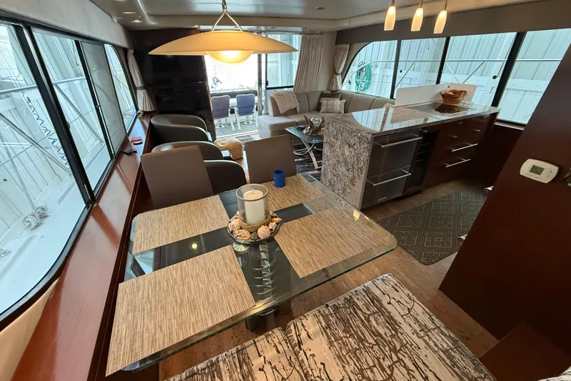  Yacht Photos Pics Luxurious interior of 1997 Bayliner 5788 Pilot House Motoryacht with elegant dining area.