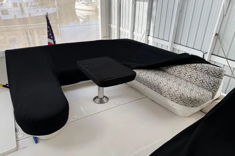  Yacht Photos Pics 1997 Bayliner 5788 Pilot House Motoryacht seating area with black covers and chevron-patterned cushions.