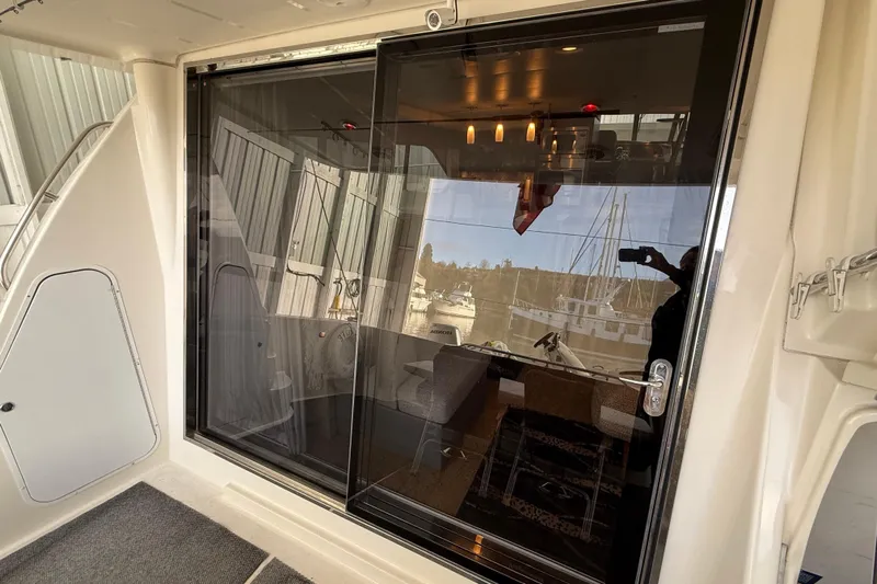  Yacht Photos Pics 1997 Bayliner 5788 Pilot House Motoryacht with glass door and interior view.