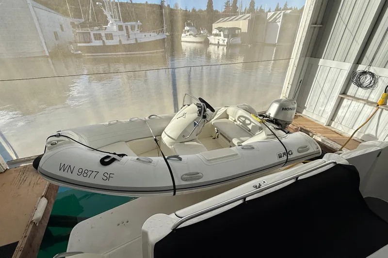 Yacht Photos Pics Inflatable boat docked beside 1997 Bayliner 5788 Pilot House Motoryacht.