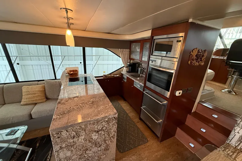  Yacht Photos Pics Luxurious 1997 Bayliner 5788 Pilot House Motoryacht interior with modern kitchen and seating area.