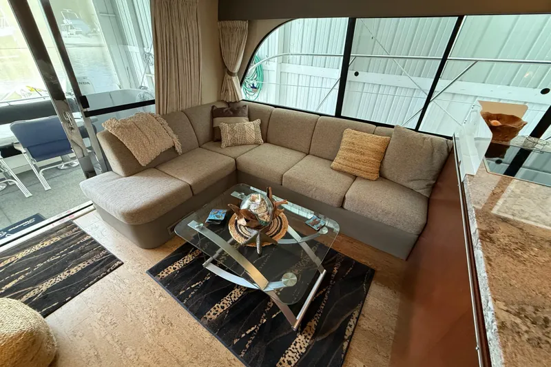  Yacht Photos Pics Luxurious interior of 1997 Bayliner 5788 Pilot House Motoryacht with cozy seating and modern decor.