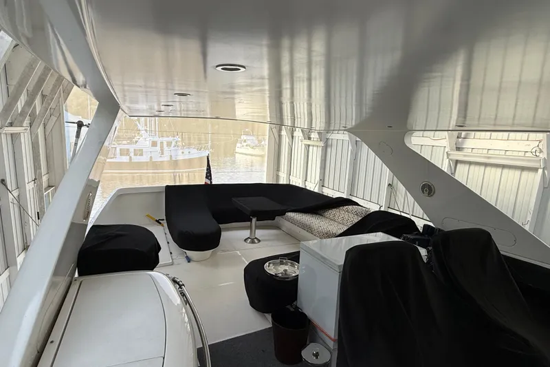  Yacht Photos Pics 1997 Bayliner 5788 Pilot House Motoryacht interior with seating and covered furniture.