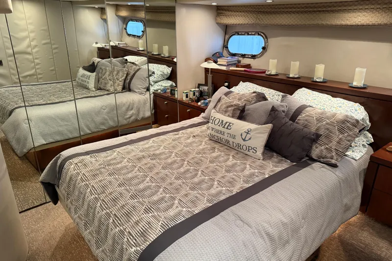 Yacht Photos Pics Luxurious bedroom interior of 1997 Bayliner 5788 Pilot House Motoryacht with elegant bedding and decor.
