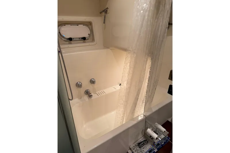  Yacht Photos Pics Bathroom in 1997 Bayliner 5788 Pilot House Motoryacht with shower and porthole window.