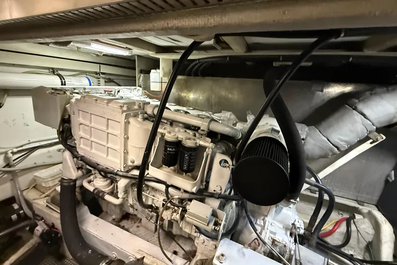  Yacht Photos Pics Engine room of 1997 Bayliner 5788 Pilot House Motoryacht, showcasing mechanical components.