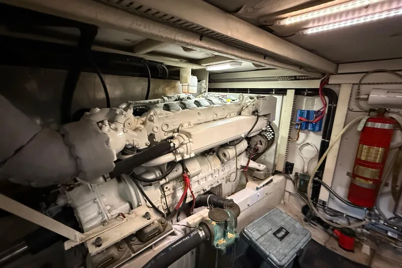  Yacht Photos Pics Engine room of 1997 Bayliner 5788 Pilot House Motoryacht, featuring a large marine engine.
