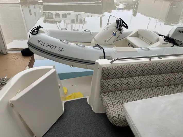  Yacht Photos Pics 1997 Bayliner Pilothouse with inflatable boat and patterned seating on deck.