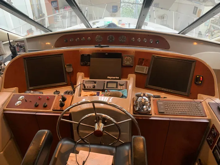  Yacht Photos Pics 1997 Bayliner Pilothouse helm with steering wheel, navigation screens, and control panels.