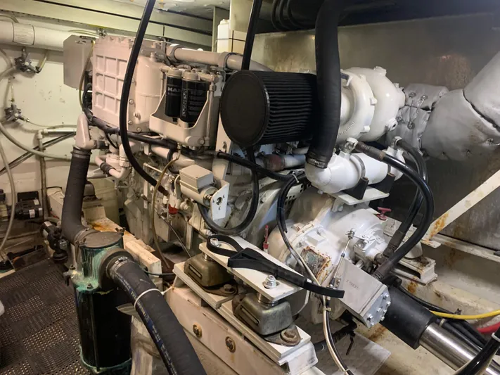  Yacht Photos Pics Engine room of a 1997 Bayliner Pilothouse boat, showcasing mechanical components and piping.