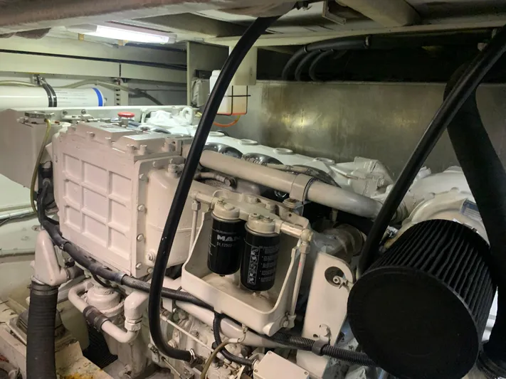  Yacht Photos Pics Engine room of a 1997 Bayliner Pilothouse boat, showcasing mechanical components and filters.