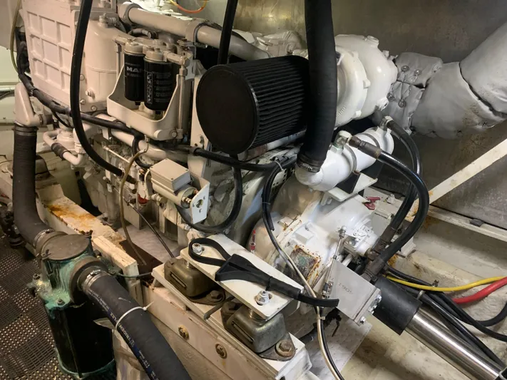  Yacht Photos Pics Engine room of a 1997 Bayliner Pilothouse boat, showcasing mechanical components and wiring.