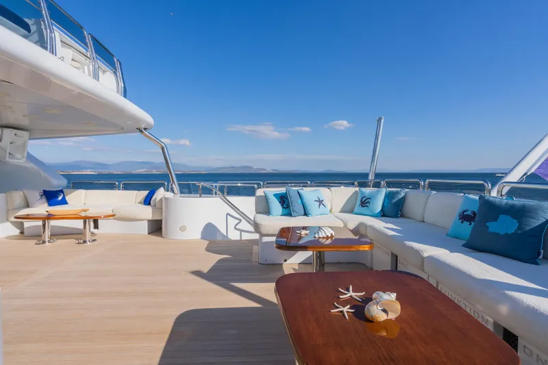 Stella Fiera Yacht Photos Pics Luxurious 1998 Benetti Classic yacht deck with elegant seating and ocean view.