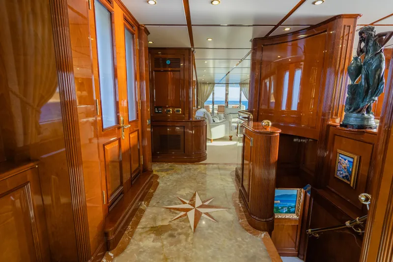 Stella Fiera Yacht Photos Pics Luxurious interior of 1998 Benetti Classic yacht with polished wood and elegant decor.