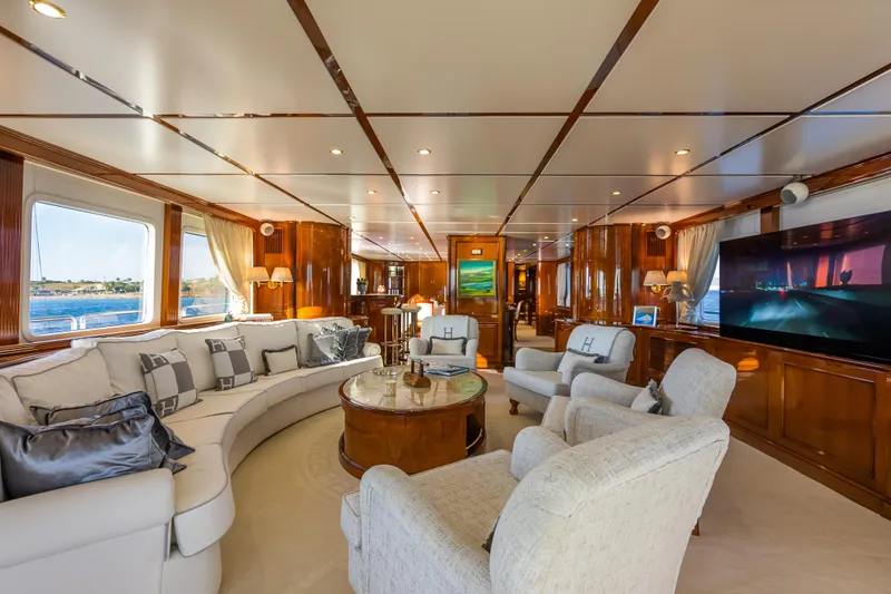 Stella Fiera Yacht Photos Pics Luxurious interior of 1998 Benetti Classic yacht with elegant seating and large windows.