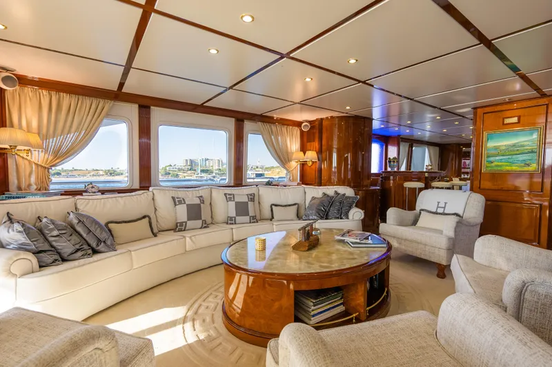 Stella Fiera Yacht Photos Pics Luxurious interior of 1998 Benetti Classic yacht with elegant seating and panoramic windows.