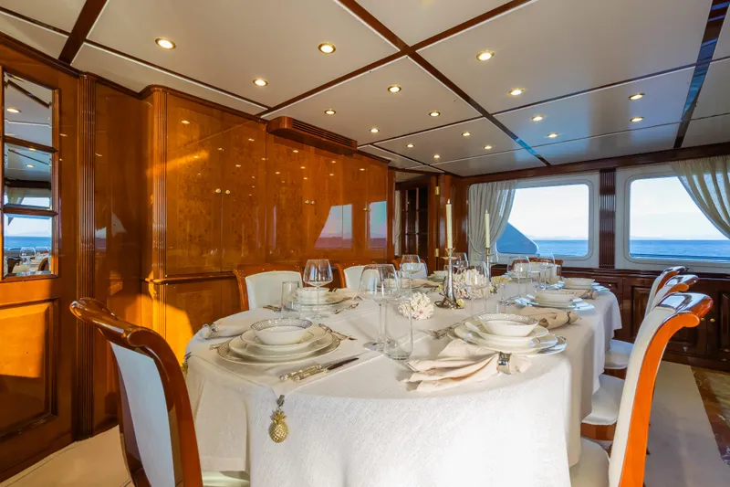 Stella Fiera Yacht Photos Pics Luxurious dining area on a 1998 Benetti Classic yacht with elegant table setting.