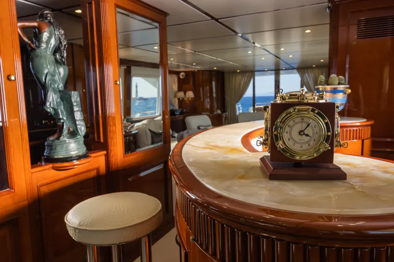 Stella Fiera Yacht Photos Pics Luxurious interior of 1998 Benetti Classic yacht with elegant decor and nautical clock.