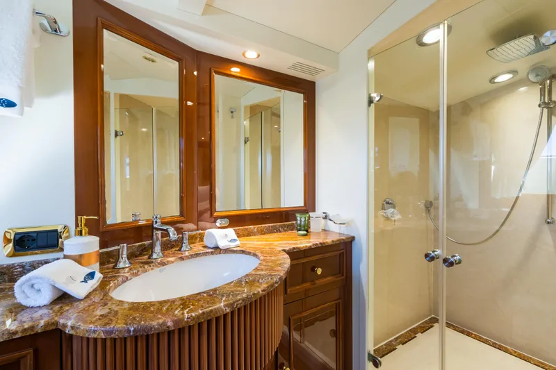 Stella Fiera Yacht Photos Pics Luxurious bathroom on 1998 Benetti Classic yacht with marble countertop and glass shower.