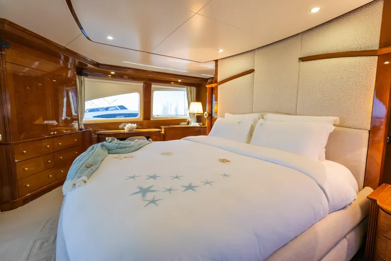 Stella Fiera Yacht Photos Pics Luxurious bedroom interior on a 1998 Benetti Classic yacht with elegant wood finishes.