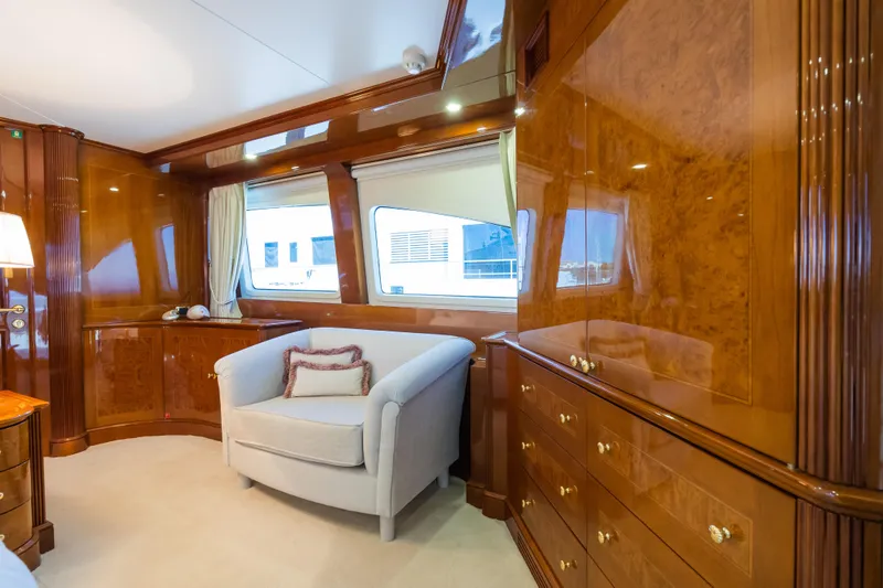 Stella Fiera Yacht Photos Pics Luxurious interior of 1998 Benetti Classic yacht with elegant wood paneling and cozy seating.