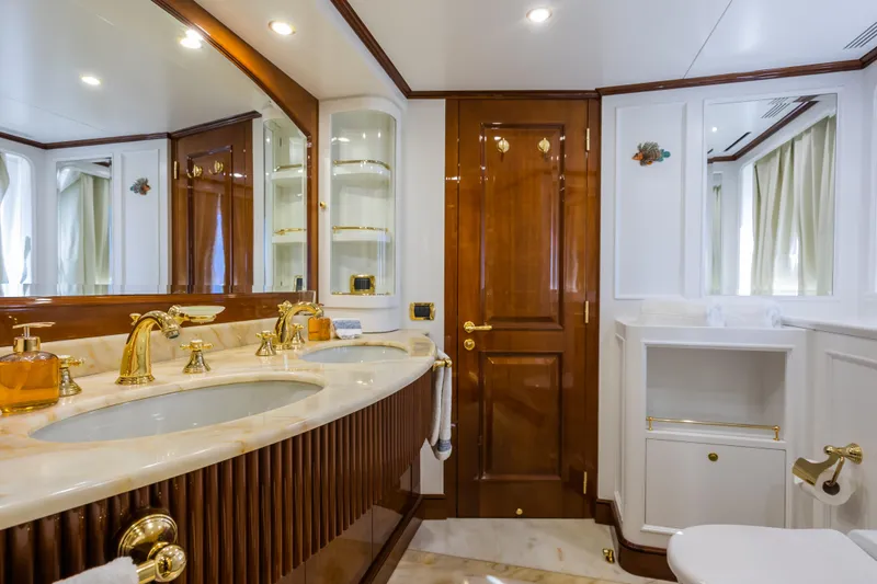 Stella Fiera Yacht Photos Pics Luxurious bathroom on 1998 Benetti Classic yacht with marble countertops and gold fixtures.