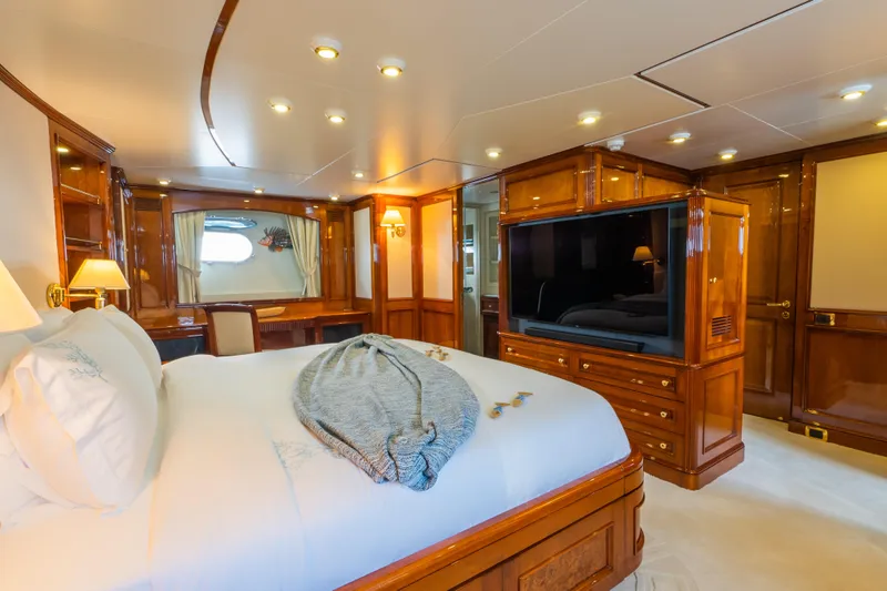 Stella Fiera Yacht Photos Pics Luxurious 1998 Benetti Classic yacht bedroom with elegant wood finishes and modern amenities.