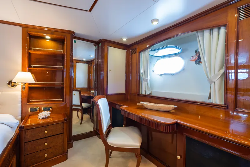 Stella Fiera Yacht Photos Pics Luxurious interior of 1998 Benetti Classic yacht with elegant wood furnishings and porthole window.