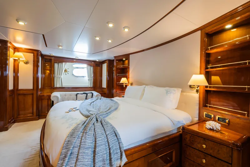 Stella Fiera Yacht Photos Pics Luxurious 1998 Benetti Classic yacht bedroom with elegant wood paneling and cozy bedding.