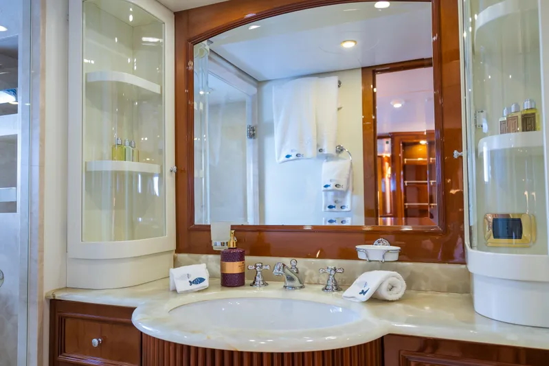 Stella Fiera Yacht Photos Pics Luxurious bathroom on 1998 Benetti Classic yacht with elegant fixtures and mirrored cabinetry.