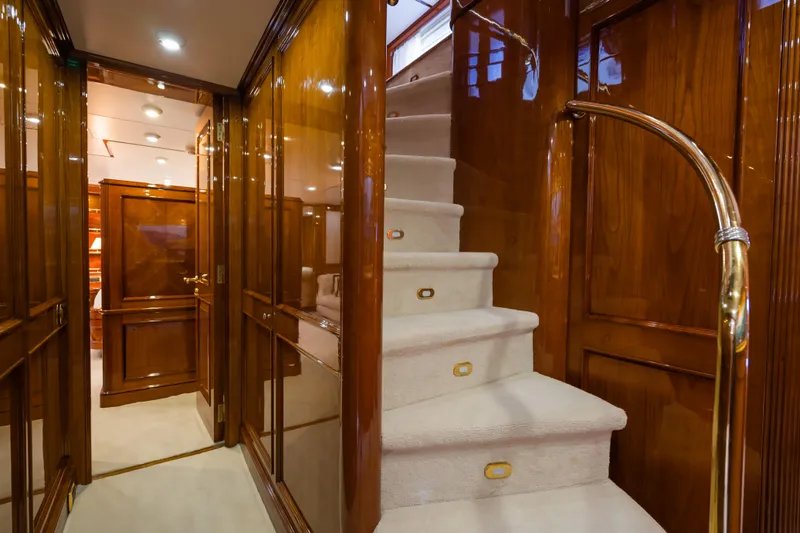 Stella Fiera Yacht Photos Pics Luxurious interior of 1998 Benetti Classic yacht with polished wood and elegant staircase.