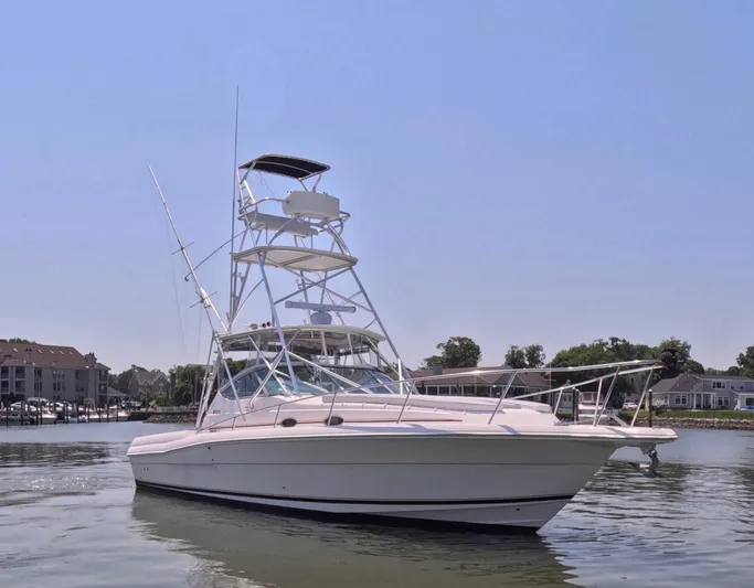  Yacht Photos Pics 2004 Stamas 370 Express boat on calm water, clear sky background.
