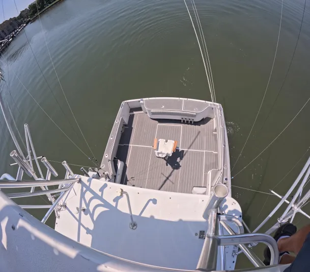  Yacht Photos Pics 2004 Stamas 370 Express boat deck view, featuring fishing chair and calm waters.