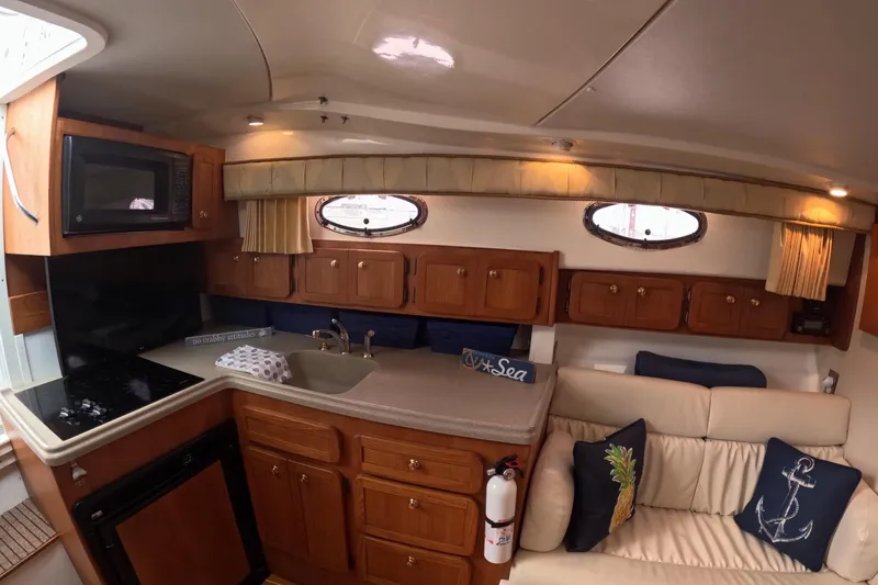  Yacht Photos Pics Interior of 2004 Stamas 370 Express yacht with kitchen and seating area.