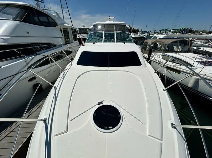  Yacht Photos Pics 2005 Cruisers Yachts 455 Express Motor Yacht docked at marina.